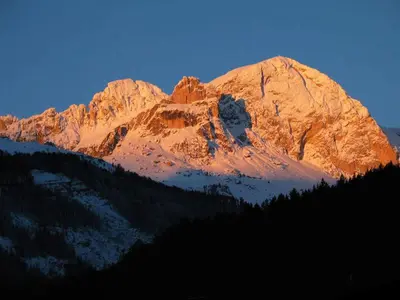 a large mountain with snow on it in the sunset at Hotel Miramonti in Vigo di Fassa