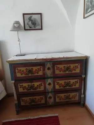 a dresser in a room with a lamp on top at Maso Pinterato in Cavalese