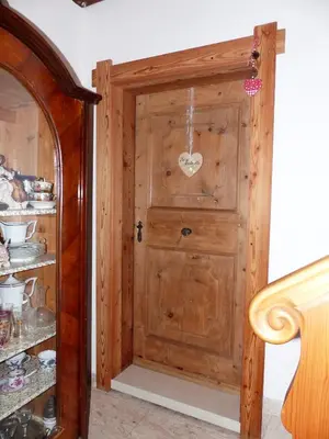 a wooden door with a heart on it in a room at Maso Pinterato in Cavalese
