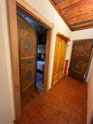 a hallway with an open door to a bedroom at Maso Pinterato in Cavalese
