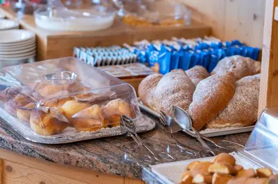 a bakery with pastries and breads on a counter at Hotel Mary in Pozza di Fassa