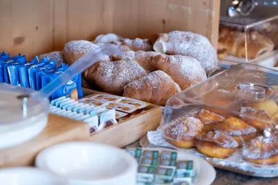 a bunch of different types of donuts on a table at Hotel Mary in Pozza di Fassa