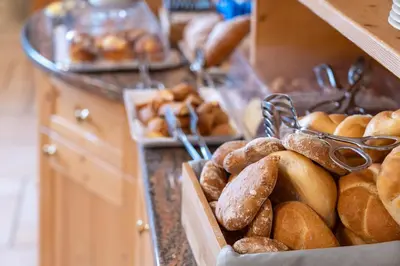 a bunch of loaves of bread on display in a bakery at Hotel Mary in Pozza di Fassa