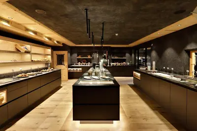 a large kitchen with a long counter in the middle at Chalet Gratznhäusl in Ridanna