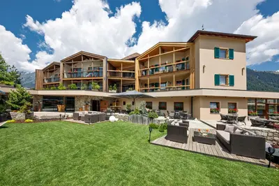 a large building with a lawn in front of it at Chalet Gratznhäusl in Ridanna