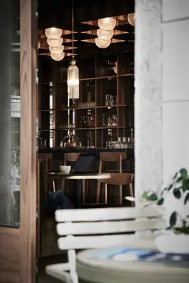 a bar with a white bench in front of a table at Hotel Jarolim in Bressanone