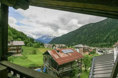 a view from a window of a village in the mountains at Casa Silva in Falcade