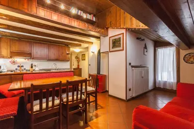 a kitchen and dining room with a table and chairs at Casa Silva in Falcade