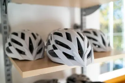 three helmets are sitting on a shelf at Hotel Alpenhof in Tirolo