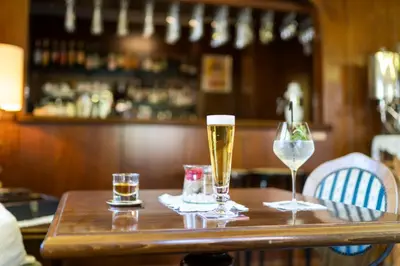two glasses of beer on a table in a bar at Hotel Alpenhof in Tirolo