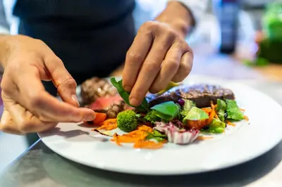 a person is eating a plate of food at Hotel Alpenhof in Tirolo