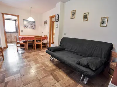 a living room with a couch and a table at Apartment Fontanelle-1 by Interhome in Alba di Canazei