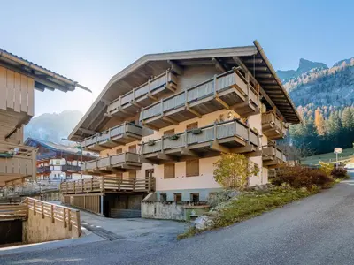 a building with wooden balconies on the side of a road at Apartment Fontanelle-1 by Interhome in Alba di Canazei