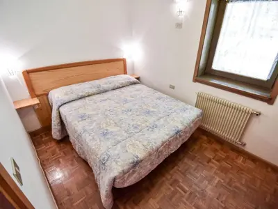 a small bedroom with a bed and a window at Apartment Fontanelle-1 by Interhome in Alba di Canazei