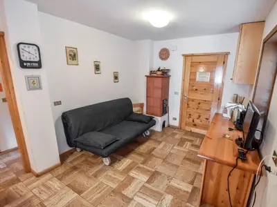 a living room with a couch and a table at Apartment Fontanelle-1 by Interhome in Alba di Canazei