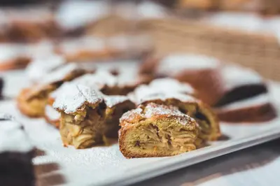 a plate of pastries with powdered sugar on them at Hotel Gasserhof in Bressanone