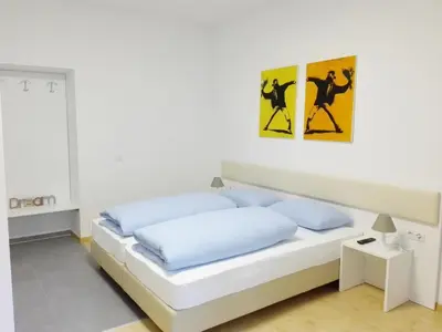 a bedroom with a bed with two posters on the wall at Manzoni Premium in Merano