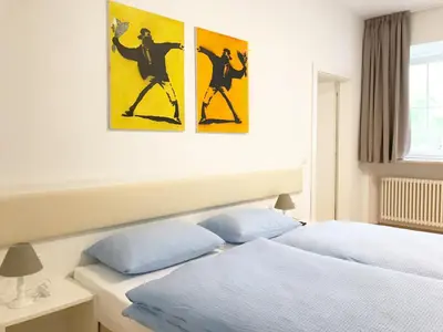 a bedroom with two posters on the wall at Manzoni Premium in Merano