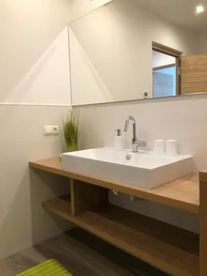 a bathroom with a white sink and a mirror at Apartment Obermair in Brunico