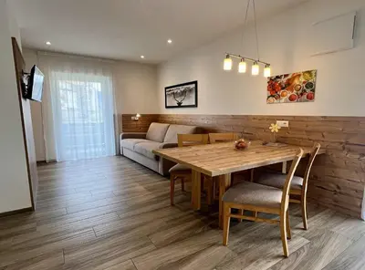 a living room with a table and a couch at Apartment Obermair in Brunico