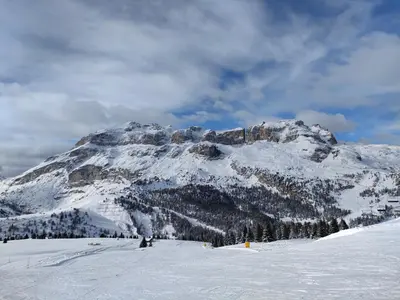 a snow covered mountain in front of a mountain at Appartamento Gliera in Arabba