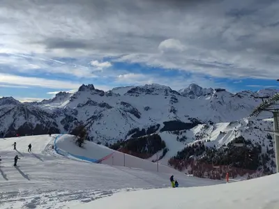 a group of people skiing down a snow covered mountain at Appartamento Gliera in Arabba