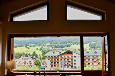 a window with a view of a mountain at CanguroProperties - Ca' Mora in Cortina dʼAmpezzo