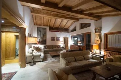 a large living room with couches and a table at CanguroProperties - Ca' Mora in Cortina dʼAmpezzo