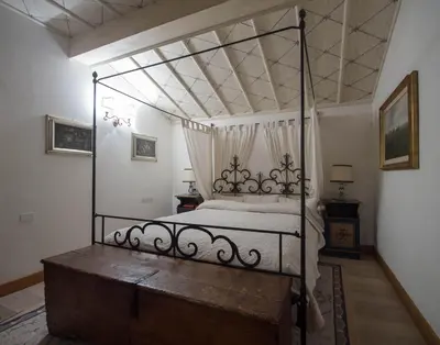 a bedroom with a canopy bed with a wooden dresser at CanguroProperties - Ca' Mora in Cortina dʼAmpezzo