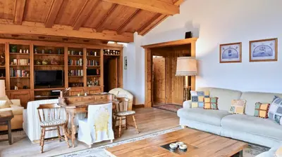 a living room with a couch and a table at CanguroProperties - Ca' Mora in Cortina dʼAmpezzo