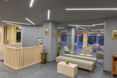 a lobby with a couch and chairs and a table at Parkhotel Fedora in Campitello di Fassa