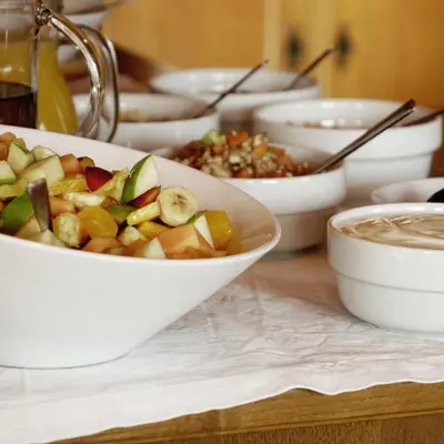 a table topped with bowls of food on a table at Tirolerhof Tisens in Tesimo