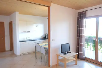 a kitchen with a small table with a tv on it at Tirolerhof Tisens in Tesimo