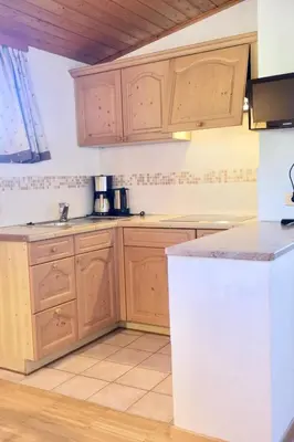 a kitchen with wooden cabinets and a counter top at Tirolerhof Tisens in Tesimo