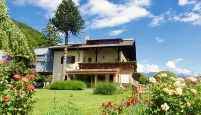 a house with a garden in front of it at Tirolerhof Tisens in Tesimo