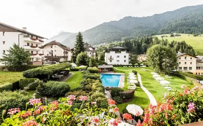 a swimming pool covered in snow next to a building at Hotel Angelo Engel in Ortisei