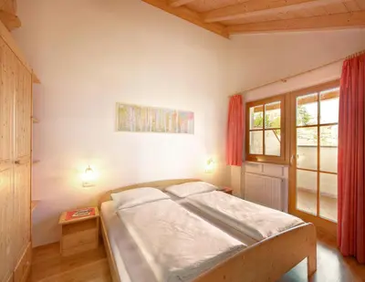 a bedroom with a bed and a window at Ferienhof 