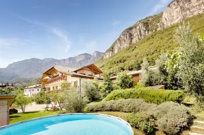 a resort with a swimming pool and mountains in the background at Ferienhof 