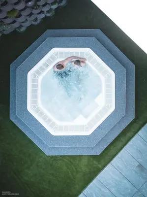 a man in a jacuzzi tub with his face at Molaris Lodge in Mühlbach