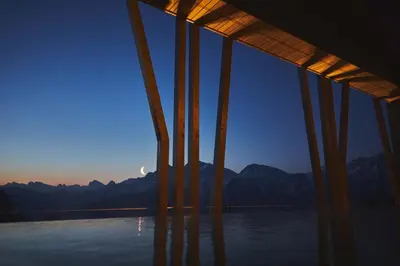 a view of the mountains from a building with the moon in the sky at Hotel Olangerhof in Valdaora