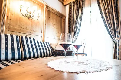 a living room with a white couch and candles at Hotel Enzian in Siusi