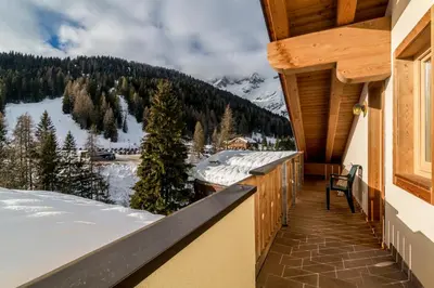 a balcony with a view of a snow covered mountain at Residence Civetta in Val di Zoldo