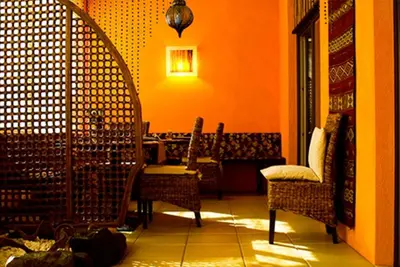 a room with chairs and a table and a light at Garni Cremona in Bressanone