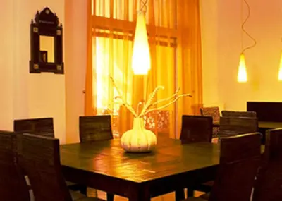 a dining room with a table with a vase on it at Garni Cremona in Bressanone