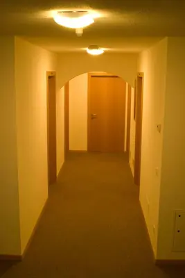 an empty hallway with a light on the ceiling at Garni Cremona in Bressanone