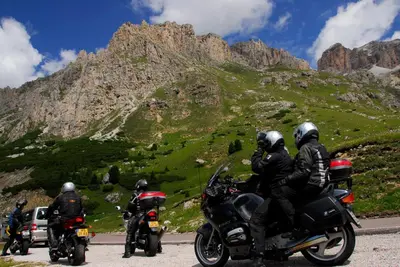 a group of people riding motorcycles on a mountain road at Hotel Rainegg in Valdaora