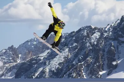 a man flying through the air on a snowboard at Hotel Rainegg in Valdaora