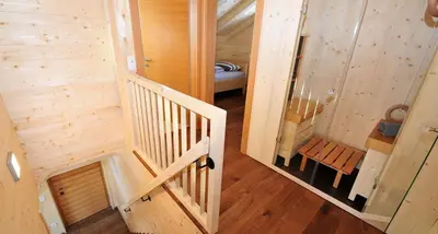 an overhead view of a wooden cabin with a staircase at Camping Chalet Salten in San Genesio Atesino
