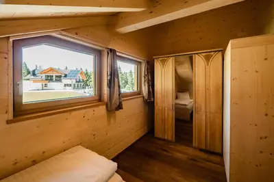 a small room with a window in a log cabin at Camping Chalet Salten in San Genesio Atesino