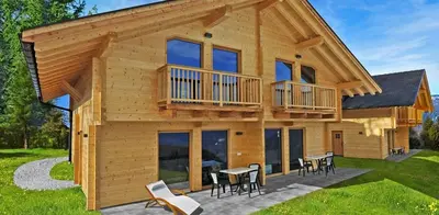 a log home with a deck and tables and chairs at Camping Chalet Salten in San Genesio Atesino